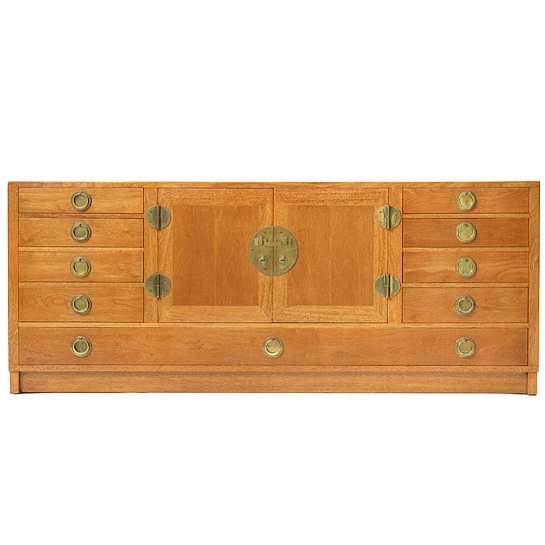 a Modernist sideboard cabinet with unique bronze hardware. by Edward Wormley for Dunbar